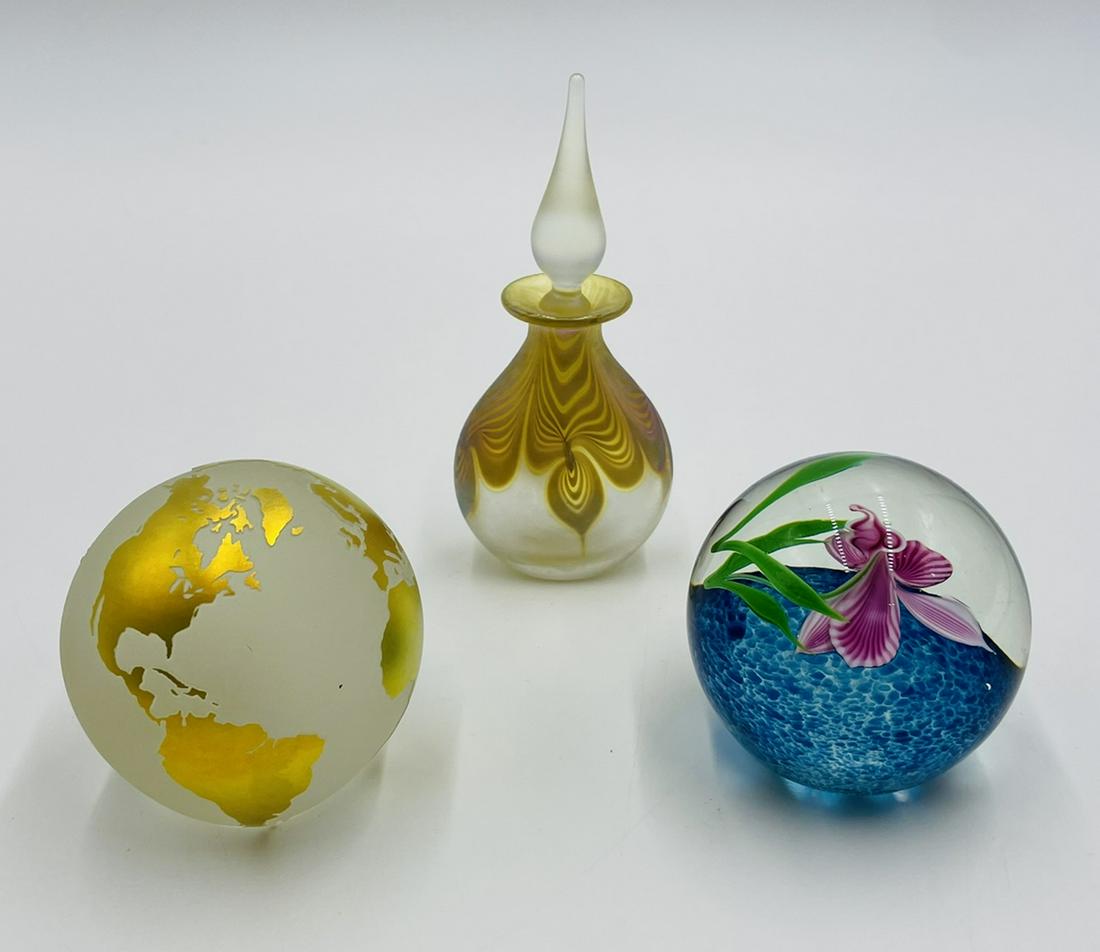 Set of 2 Studio Art Glass Paperweights & A Perfume Bottle by Correia Art Glass, Signed: Set of 3 studio art glass pieces, all by Correia art glass, signed and dated. One is a World globe with gold etching, the second one is a reef with leaves and a flower and the third is a perfume bottl