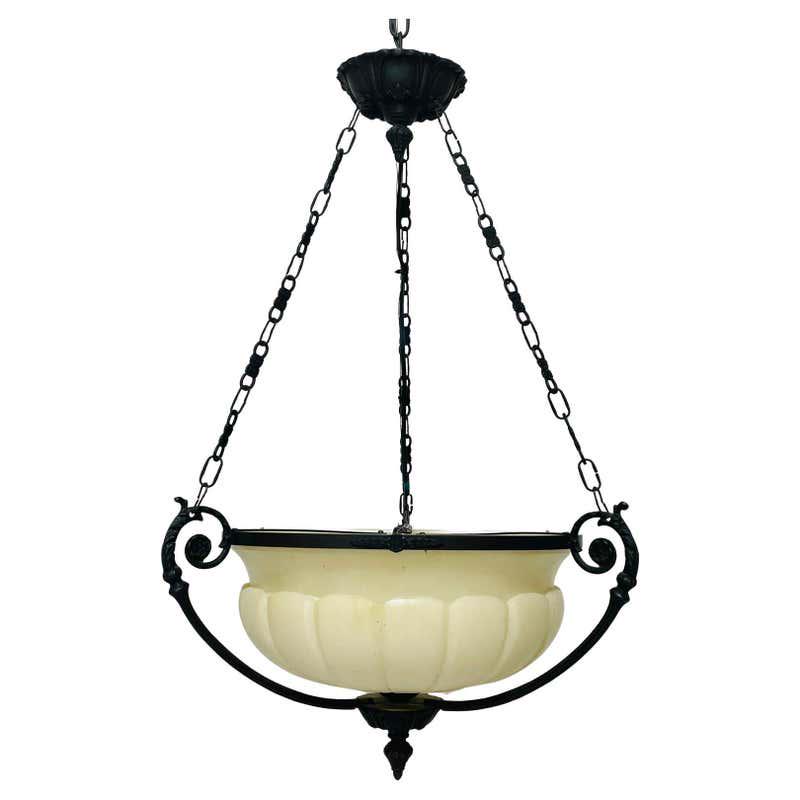 Alabaster & Bronze Spanish Chandelier: Beautiful chandelier in alabaster and bronze hardware.The chandelier takes 3 60 watt light bulbs. The chandelier is made in Spain, the hardware and chain is bronze, and the alabaster shade has a beau