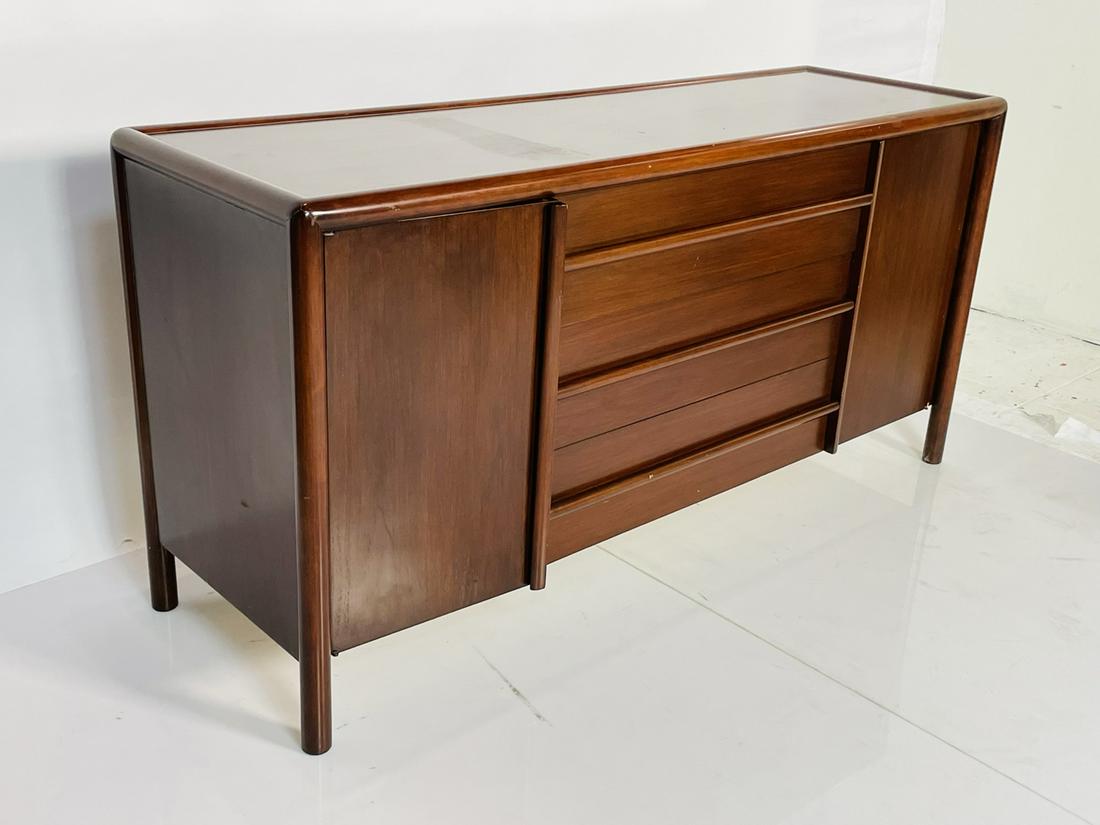 Walnut Cabinet/Sideboard by T. H. Robsjohn-Gibbings: Beautiful sideboard cabinet designed and manufactured in the 1950s by T.H. Robsjohn Gibbings.The piece has 3 large drawers and two side cubbies for extra storage.Great design with great proportions.Me