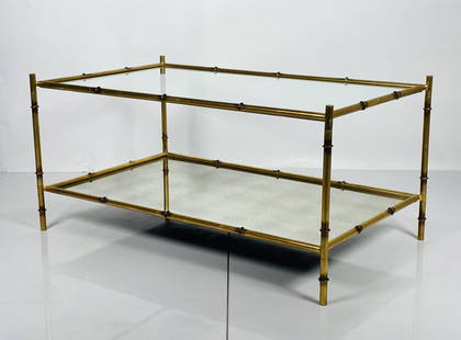 Faux Bamboo & Antique Glass Coffee Table: Vintage style coffee table with a faux bamboo and gold frame coffee table with antiqued glass top.Measurements:42 inches wide x 25.50 inches deep x 20 inches high. All items are sold as is. The