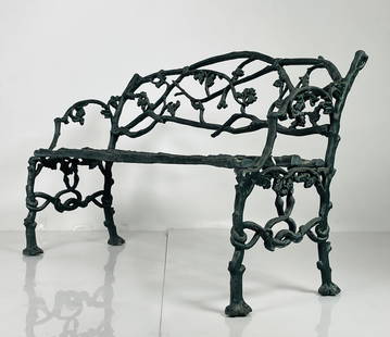 Mid-19th Century English Iron Garden Bench: This fine early bench cast between 1830 and 1850 is in a naturalistic twig form covered sparingly with leaves. The bench is a very heavy casting and while simple looking is very detailed and well-conc