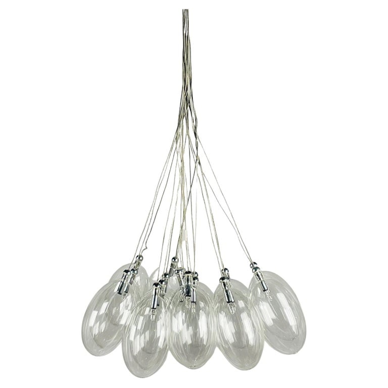 Modern Glass Chandelier: This stunning chandelier is perfect for adding a modern touch to any room. Crafted from clear glass, this light features a sleek design that will make a statement in any home. The clear glass allows f