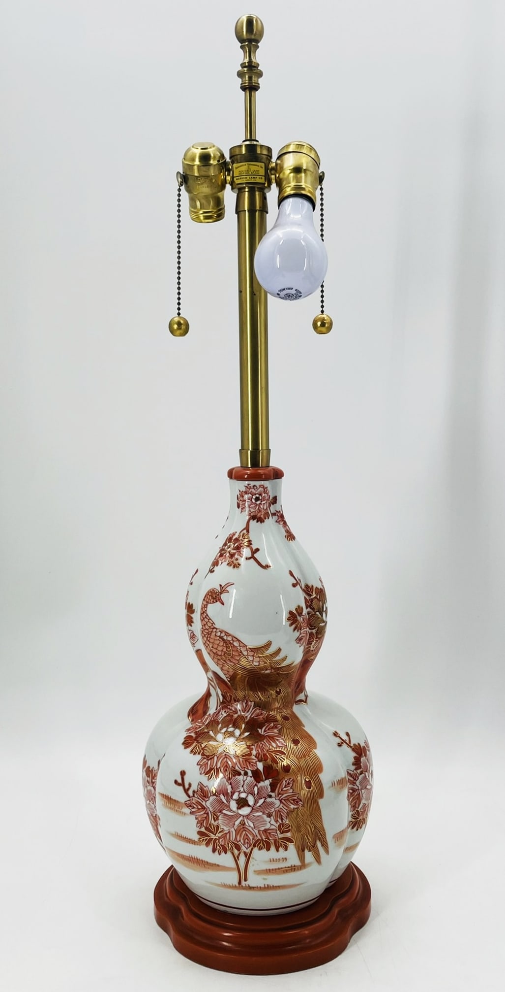 Chinoiserie Style Table Lamp by Marbro Lamp Company: Beautiful table lamp in the Chinoiserie style designed and manufactured by Marbro Lamp Corporation. The main body is made out of ceramic with hand painted peacocks, foliage and flowers in bright colo