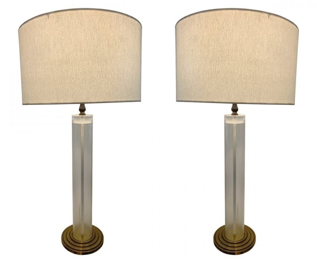 Pair of Midcentury Modern Lamps in Lucite & Brass: Pair of midcentury modern lamps designed and manufactured in the USA in the 1960s. The main body is frosted Lucite with graduated brass base. Measurements: 29 inches high to top of finial x 18 inches