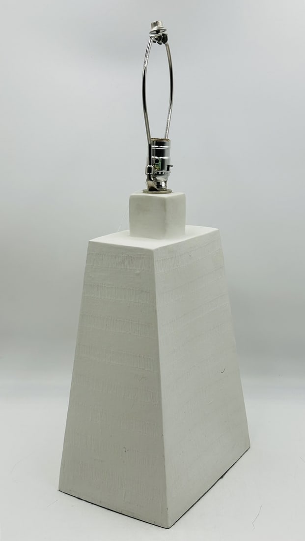 Ceramic Table Lamp with Textured Finish: Modern lamp with a white ceramic base with a textured finish. No shade. Measurements: 26 inches high x 10 inches wide x 7.25 inches deep. All items are sold as is. The auction house does not warrant a