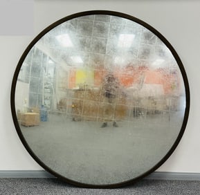 Restoration Hardware Round Wall Mirror with an antique brass frame and silverleaf finish.