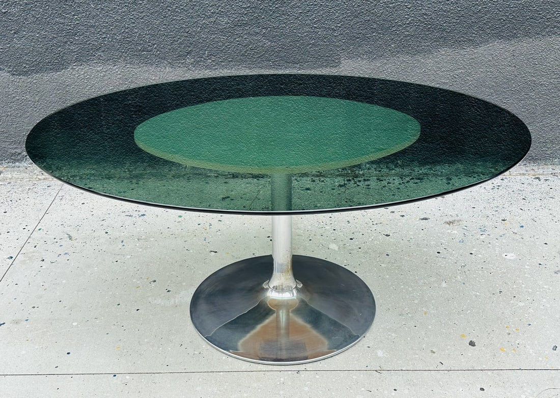 Chrome and Smoked Glass Dining Table in the Style of Chromecraft: 1960s oval pedestal dining table with chrome base & smoked glass top in the style of Chromecraft. With white vinyl on pedestal base. Measurements: 60 inhces wide x 46 inches deep x 27 inches high. All