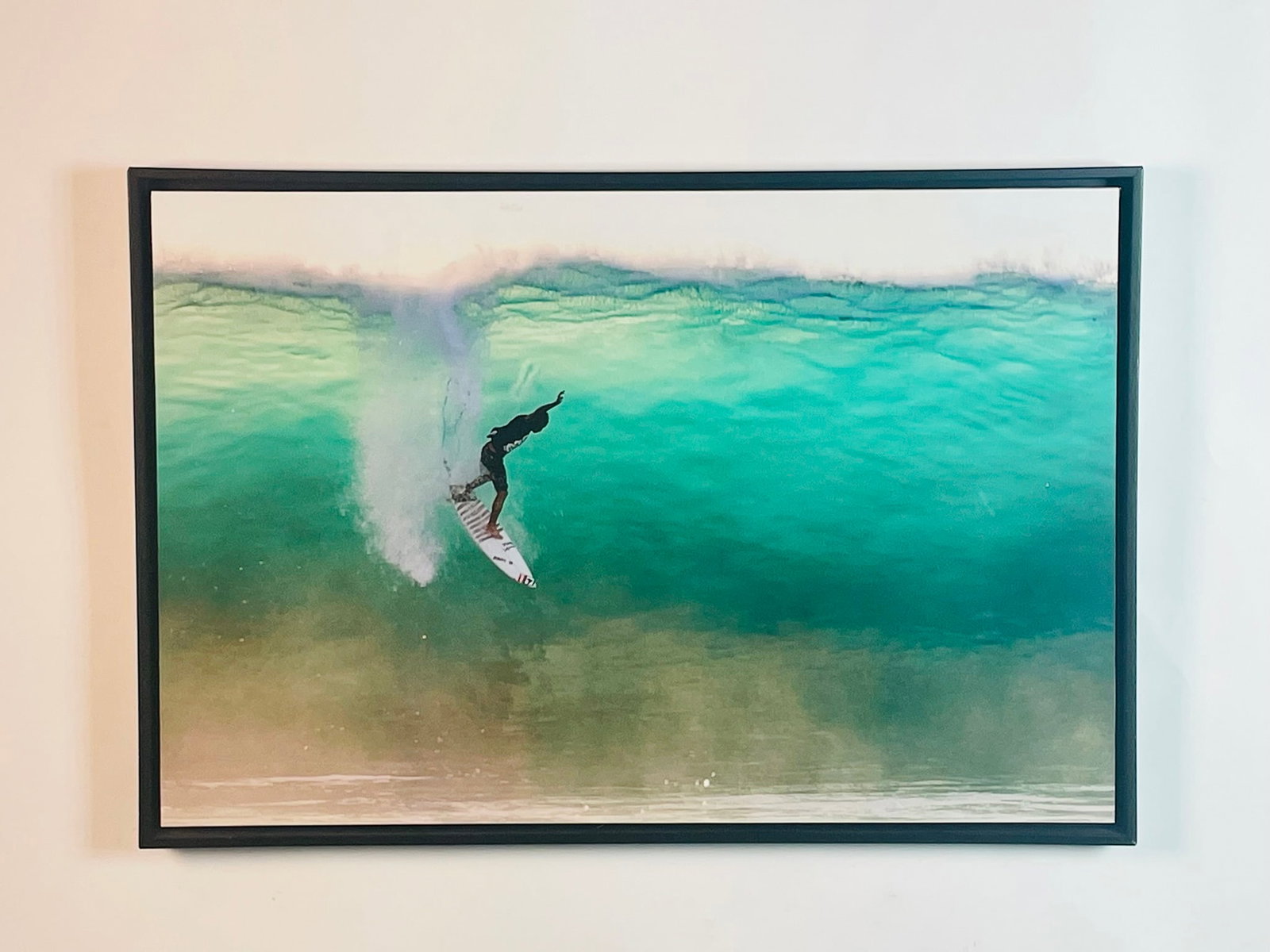 Surfer Arwork Print On Board: Photograph print of foam board of a surfer. Measurements: 33 inches wide x 22.25 inches high x 1.75 inches deep/projection from the wall. All items are sold as is. The auction house does not warrant a