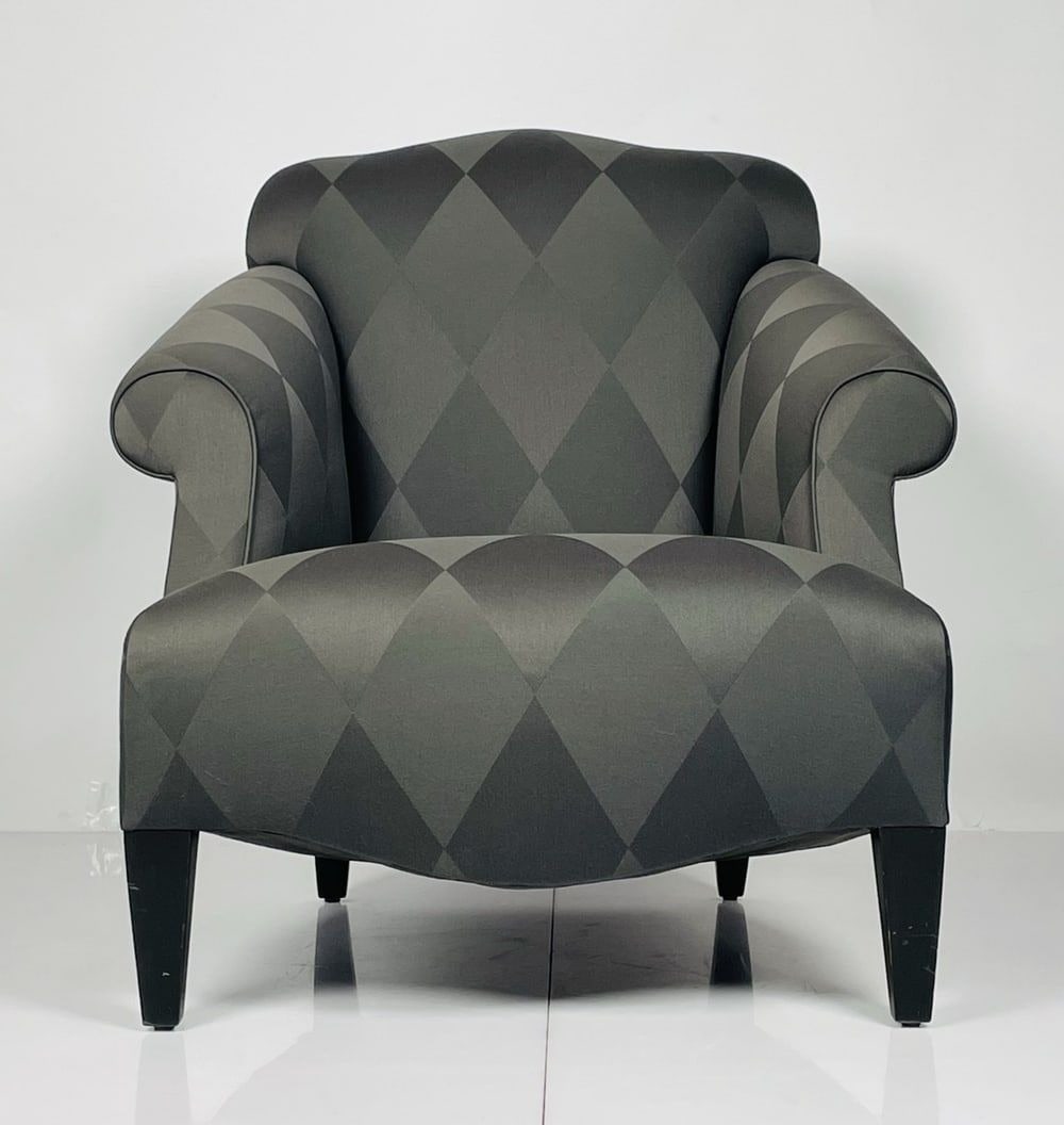 Luciano Lounge Chair Designed by John Hutton for Donghia: Beautiful Luciano Lounge chair designed in the United States by John Hutton and manufactured by Donghia. The chair is upholsted and a black and dark gray fabric, the chair is generous in size and very