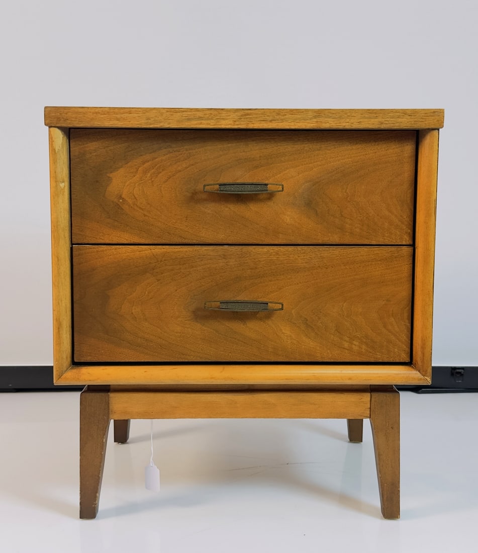 Single Walnut Nightstand, USA 1960s: Vintage nightstand with two drawers, unmarked. Measurements: 22.25 inches wide x 15 inches deep x 24.25 inches high. All items are sold as is. The auction house does not warrant authenticity on any sp