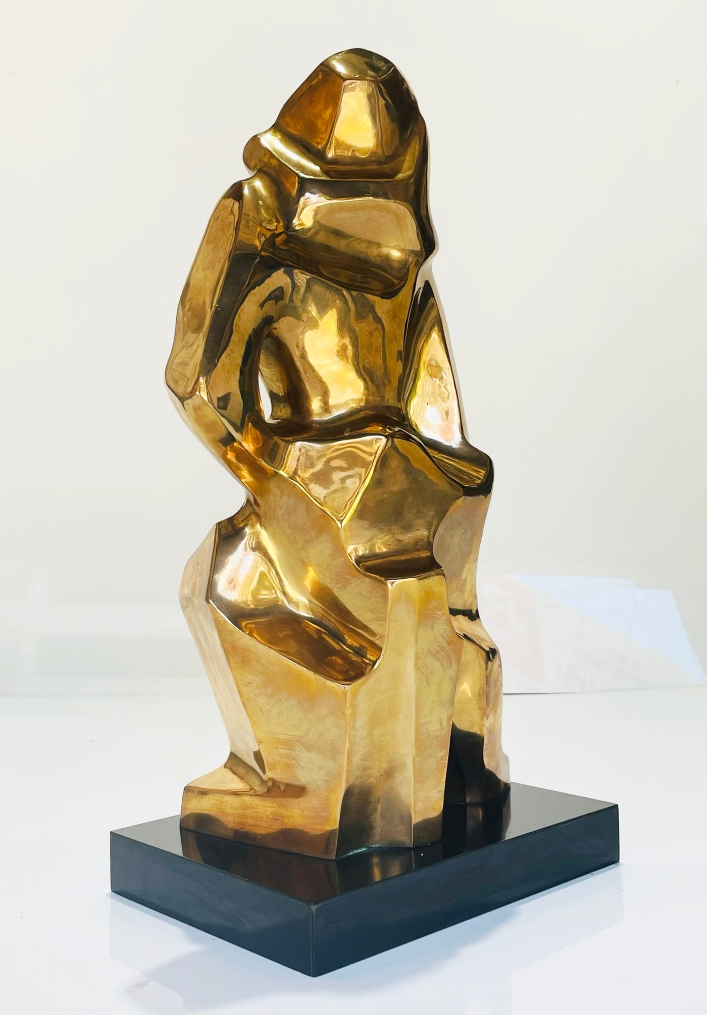 Cubist Style Bronze Sculpture by Caroline Newhouse (American 1910-2003): Stunning bronze sculpture in the cubist style by American artist Caroline Newhouse (American 1910-2003. The sculpture depicts a woman with one hand on her waist and the other one across her legs while