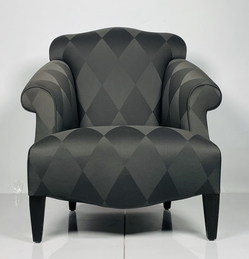 A Glamorous -Luciano- Chair by Donghia: Luciano lounge chair designed by John Hutton and manufactured by Donghia. Very comfortable featuring out swept rolled arms with tight seat and back. Exposed wood legs are finished in black. The chair