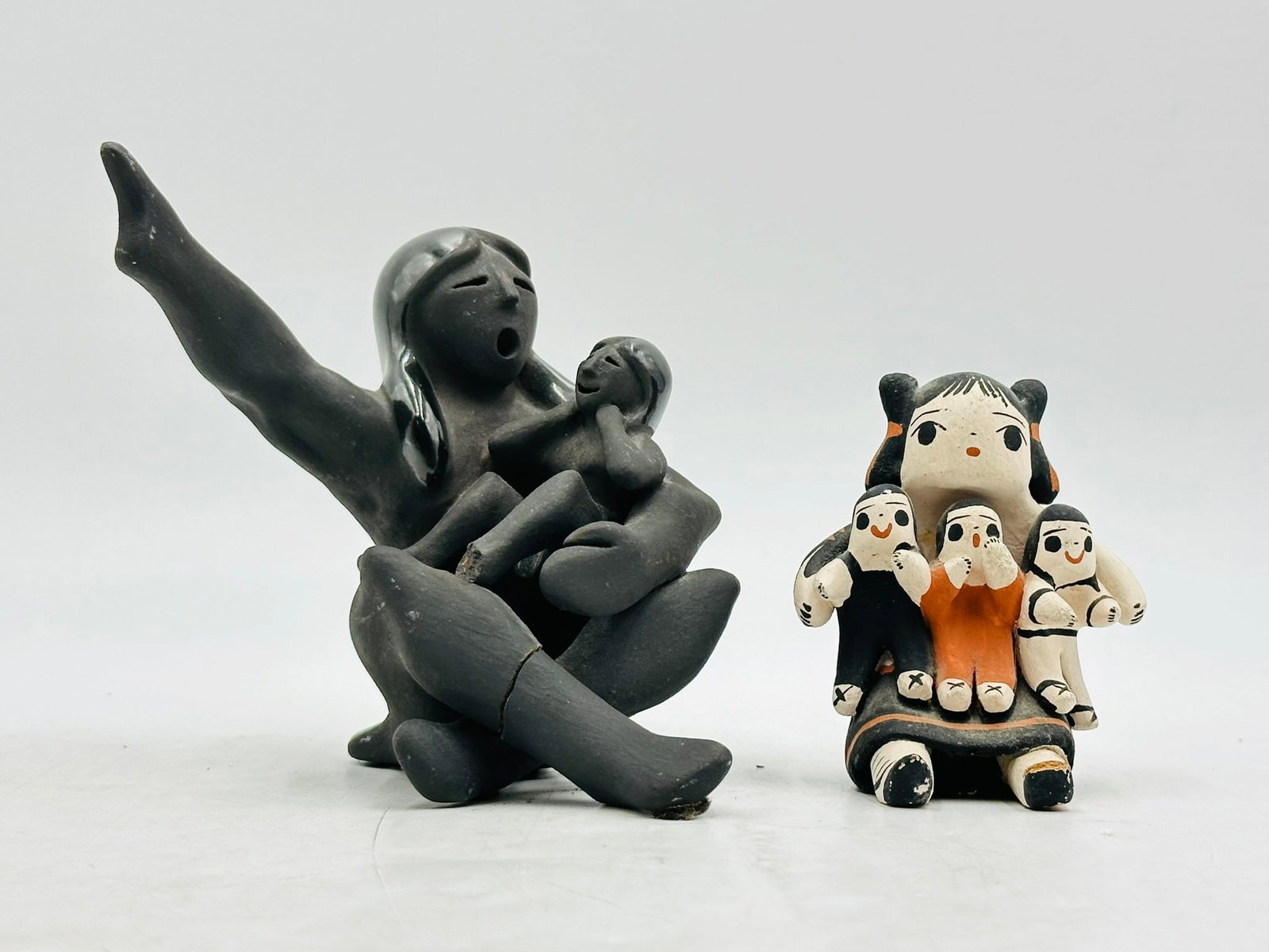 Dorothy Herrera & Gary Gutierrez Native American "Pueblo" Figurines, Signed & Dated: Vintage native American pottery pieces made by Gary Gutierrez and Dorothy Herrera. Both are signed and one is dated 99. Measurements; Black piece; 4.50 inches high x 5 inches wide x 3.50 inches deep, 