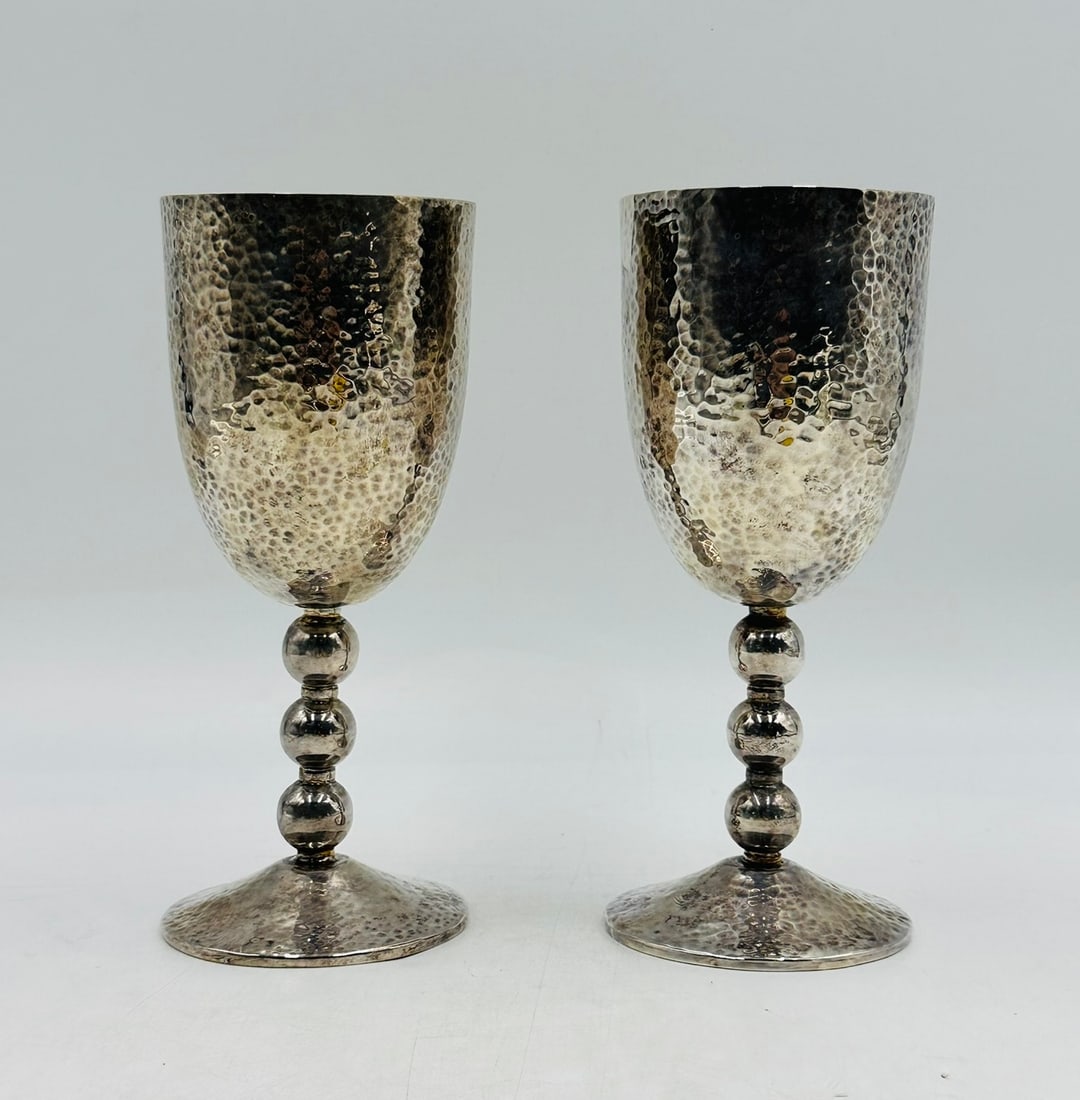Pair of Hammered Silver "Musical Goblets" by Emilia Castillo, Hand-Signed: Pair of "Musical" water or wine goblets designed and manufactured in Taxco Guerrero by Emilia Castillo. The pieces have a hammered finish, they are silver-plated and both are hand-signed by the artist