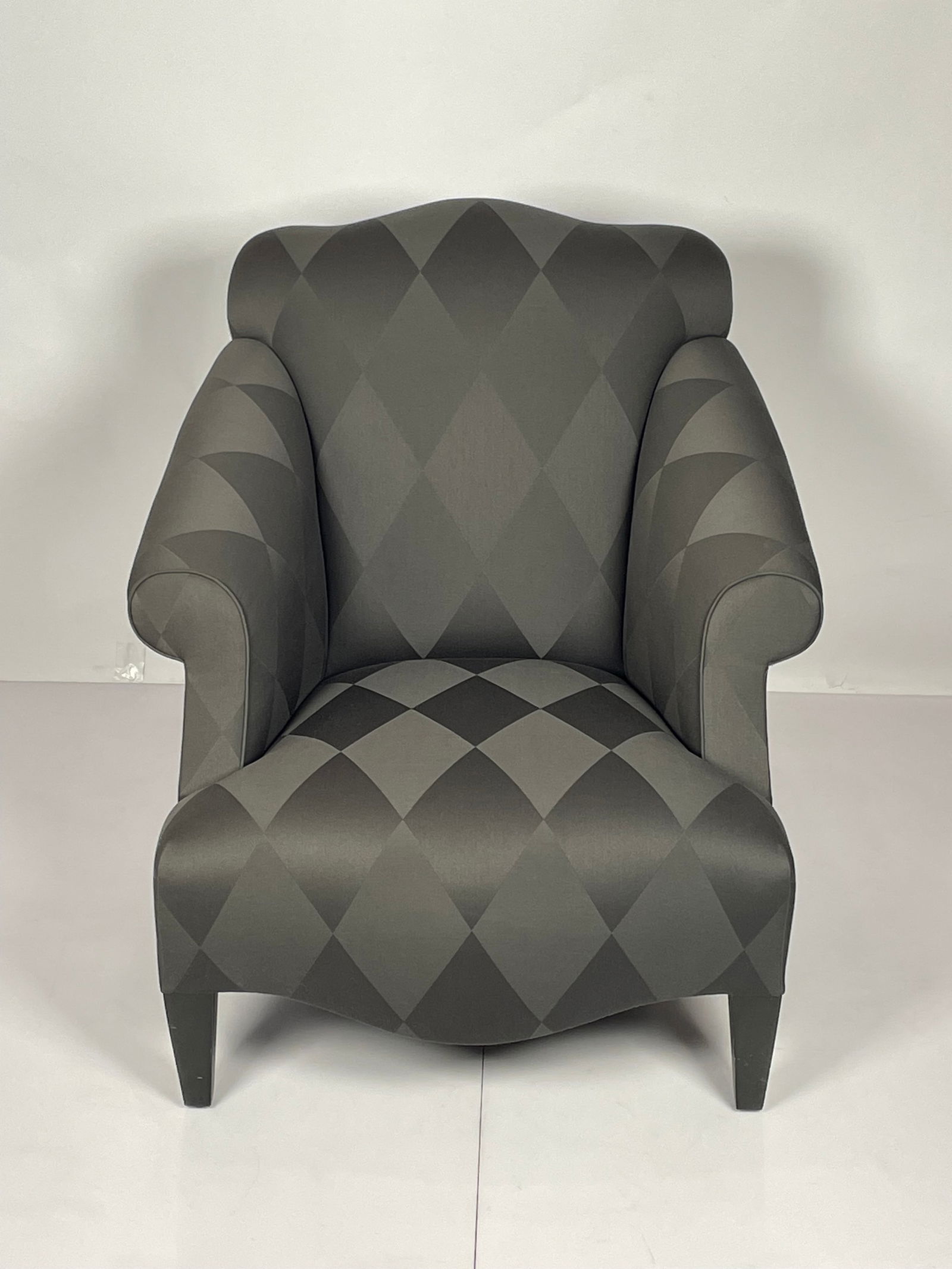 A Glamorous -Luciano- Chair by Donghia: Luciano lounge chair designed by John Hutton and manufactured by Donghia. Very comfortable featuring out swept rolled arms with tight seat and back. Exposed wood legs are finished in black.The chair r