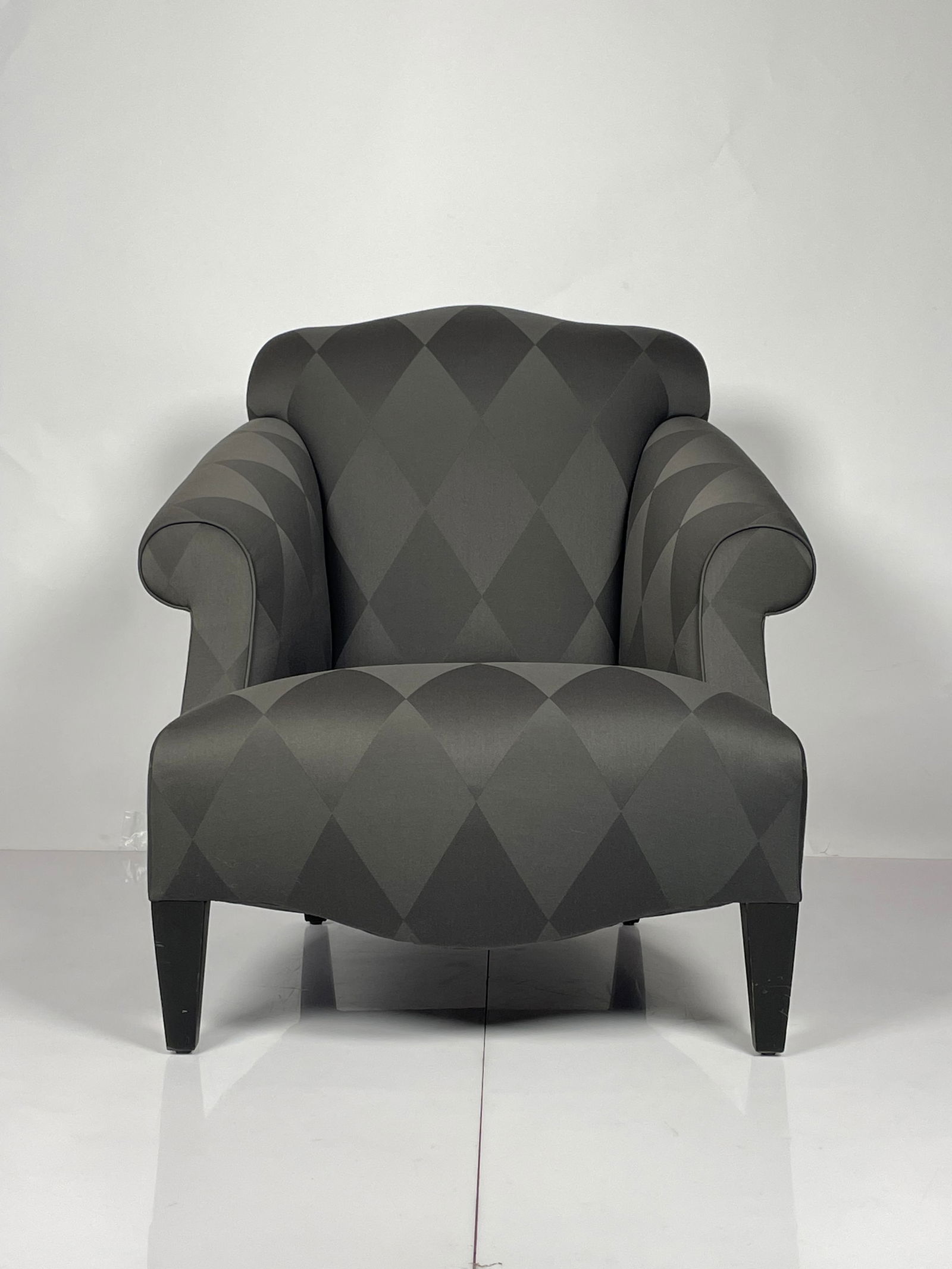 A Glamorous -Luciano- Chair by Donghia: Luciano lounge chair designed by John Hutton and manufactured by Donghia. Very comfortable featuring out swept rolled arms with tight seat and back. Exposed wood legs are finished in black.The chair r