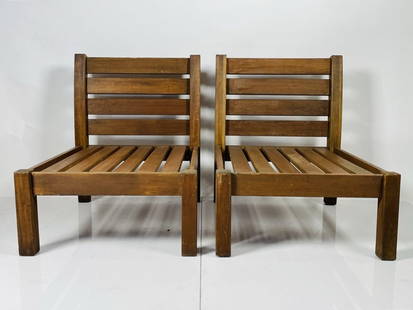 Pair of Outdoor Lounge Chairs in Solid Teak: Pair of outdoor lounge chairs made in solid Teak. Measurements: 33 inches high x 27.50 inches wide x 34.25 inches deep x 18.50 inches seat height. All items are sold as is. The auction house does not