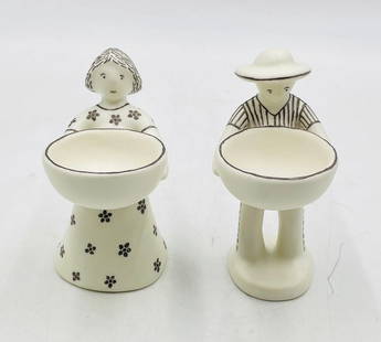 “Ella y Él” Porcelain & Pure Silver Sculptures by Emilia Castillo, 1995: A charming and signed pair of figural table sculptures by acclaimed Mexican artist Emilia Castillo, titled “Ella y Él” and dated 1995. Crafted in fine porcelain with hand-applied pure silver