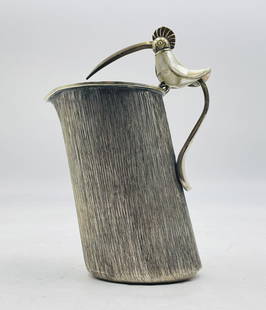 Los Castillo Silver Plate Pitcher with Inlaid Bird Handle, Mexican Modernist Design: Striking silver-plated pitcher by celebrated Taxco silversmiths Los Castillo, showcasing a vertically textured, hand-hammered body and a sculptural bird-form handle. The bird is detailed with mother-o