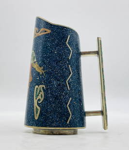 Sculptural Mexican Mixed Metal Pitcher w/ Pre-Columbian Motif & Stone Inlay: A visually arresting handcrafted Mexican mixed-metal water pitcher, richly inlaid with crushed lapis lazuli, malachite, copper, and brass. Featuring a sculptural tapered form with bold geometric motif