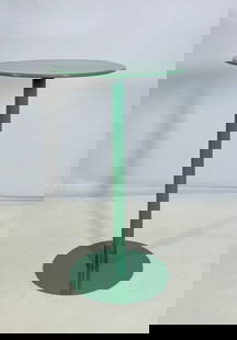 Contemporary Green Metal Bistro Table with Round Top: A sleek and modern bistro table featuring a round metal top in a glossy green finish. The minimalist design includes a single cylindrical pedestal stem and a circular base, providing both visual
