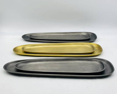 Set of 6 Modern Elongated Metal Trays in Brass and Antique Nickel Finishes: A stylish and versatile set of six elongated decorative trays in graduated sizes, featuring two warm brass-toned pieces and four in antique nickel finish. These sleek, sculptural trays are ideal for s