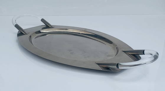 Mid-Century Modern Oval Serving Tray with Lucite Handles: A striking mid-century modern oval serving tray featuring sleek polished metal construction paired with clear Lucite handles for a contemporary flair. The streamlined silhouette and minimalist aesthet
