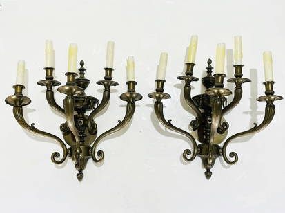 Pair of Five-Arm Spanish Bronze Wall Sconces: Striking pair of Spanish wall sconces, each with five gracefully scrolling arms in solid cast bronze. These elegant fixtures feature rich classical details including urn finials, fluted central column