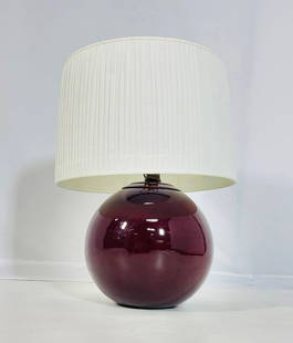 Haeger Burgundy Ceramic Table Lamp with White Pleated Shade: This elegant table lamp by Haeger Pottery features a rich burgundy ceramic base with a smooth, glossy glaze that reflects its mid-century charm. The rounded globe form offers a clean, modern silhouett