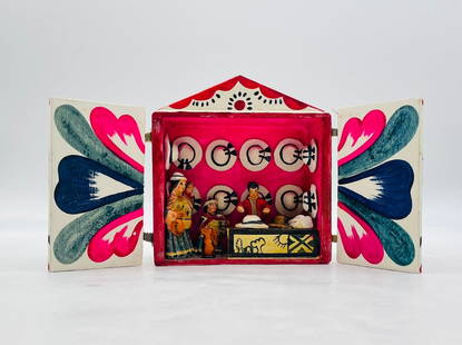 Hand-Painted Peruvian Retablo with Ceramic Figures – Folk Art Hat Shop Scene: A vibrant and charming hand-crafted Peruvian retablo, featuring a miniature diorama of a traditional hat shop. This colorful folk art piece is composed of a wooden box with hinged doors, hand-painted
