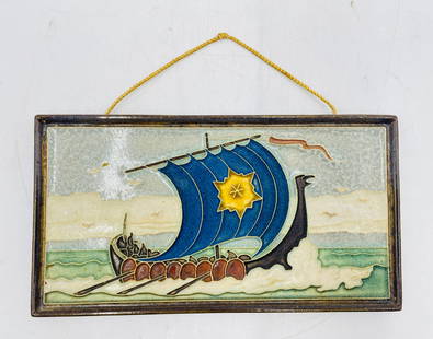 Hand-Glazed Dutch Delft Ceramic Tile Plaque Depicting Viking Longship – Marked: A striking mid-century Dutch Delft ceramic wall plaque depicting a stylized Viking longship sailing across ocean waves. The composition features a bold cobalt blue sail adorned with a yellow starburst
