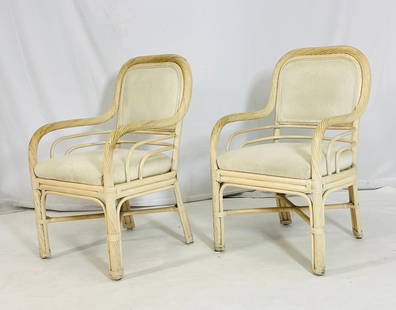 Pair of Vintage Rattan Lounge Armchairs with Cream Upholstery, Coastal Modern Style: Charming pair of vintage rattan armchairs featuring sculptural frames with twisted reed detailing and double-arm rail design. These chairs exude relaxed coastal elegance and are upholstered in a soft,