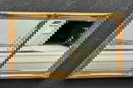 Vintage Wall Mirror with Ornate Gold Gilded Frame: Vintage wall mirror having a beautiful ornate frame.Unmarked.Measurements: 56.50 inches wide x 32.50 inches high x 2.50 inches deep/projection from the wall.All items are sold as is. The auction house
