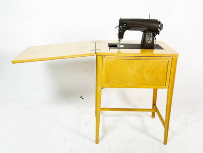 Antique Kenmore Sewing Machine with cabinet model # E-6354: 1938 electric powered rotary sewing machine made by Kenmore in 1942. The piece powers on but otherwise untested. The sewing machine comes in the original stand and it folds away so the stand can be us