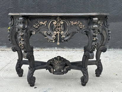 Hand Carved Console Table in a Black Finish: Hand carved console table with a black finish. Measurements: 50 inches wide x 15.25 inches deep x 32.75 inches high. All items are sold as is. The auction house does not warrant authenticity on any