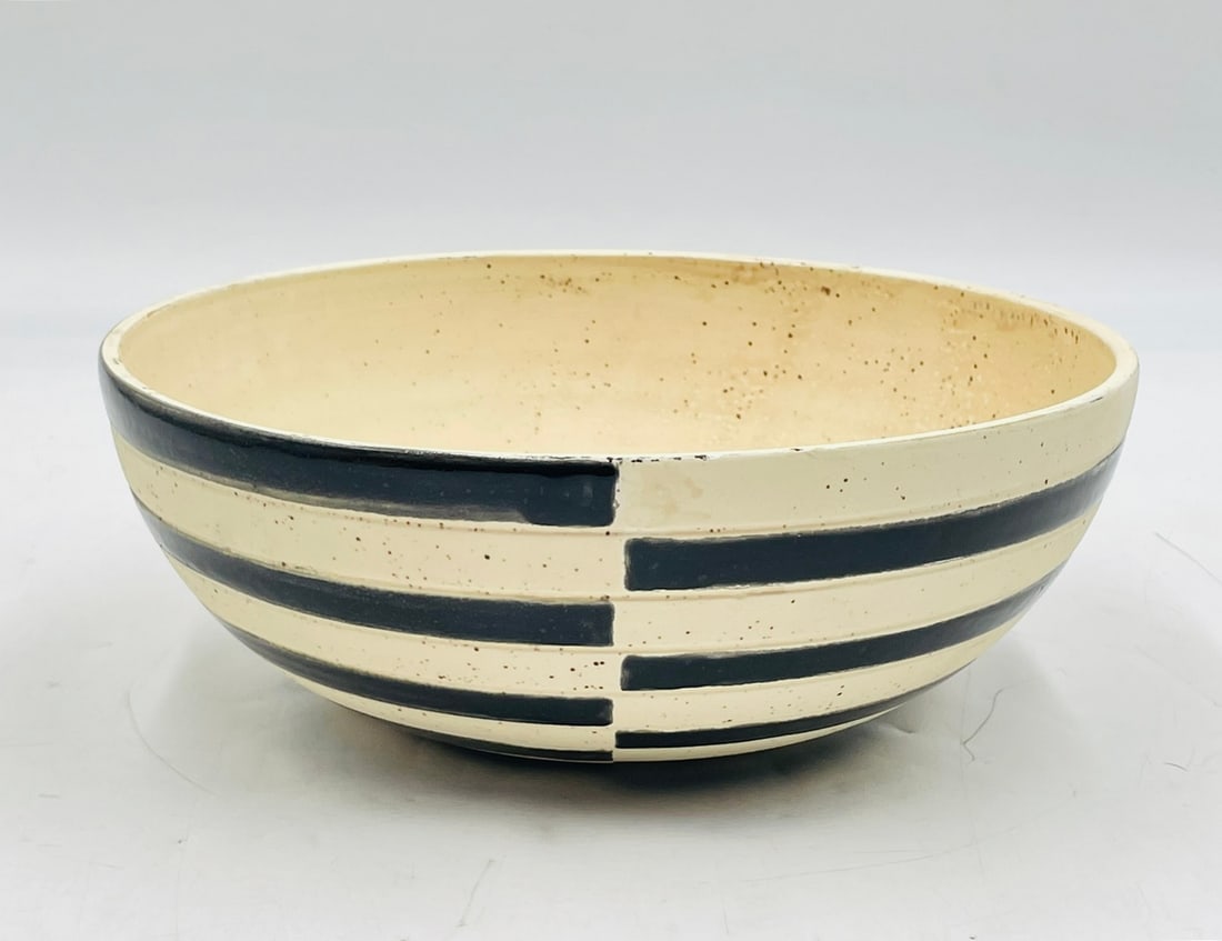 Vintage Ceramic Bowl in the style of Harrison McIntosh (American 1914-2016): Cream colored bowl with black bands around. Apparently unmarked. Measurements: 10.50 inches in diameter x 4 inches high. All items are sold as is. The auction house does not warrant authenticity on an
