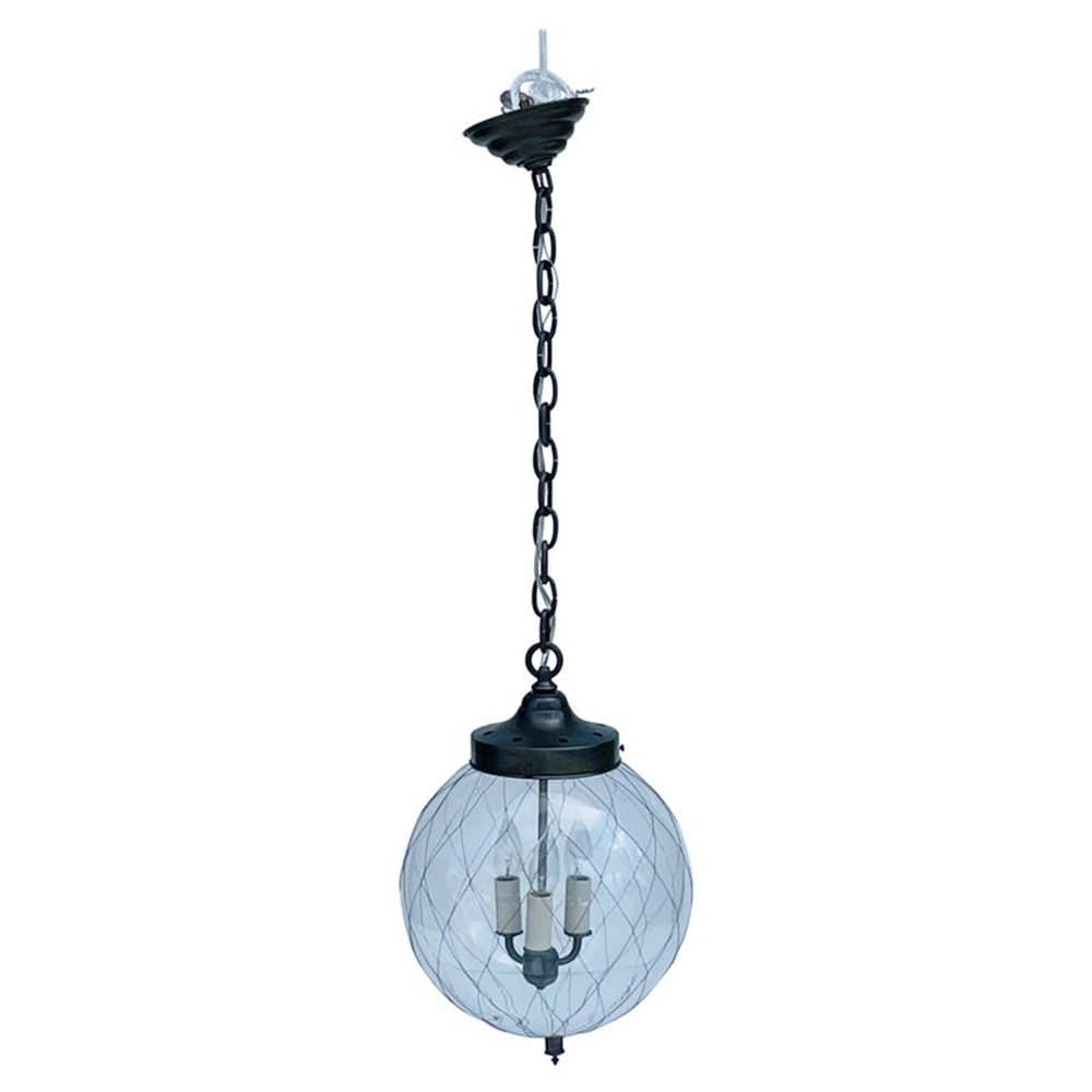 Sorenson 12 Pendant Light/Chandelier by Remains: This versatile lantern references a form of historical factory lighting where the glass was netted for safety. The thick clear mouth-blown glass is wrapped in a hand-woven wire fabric. Each with sligh
