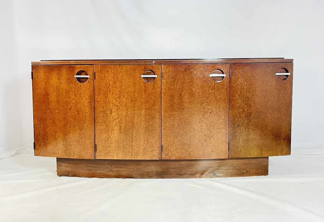 Vintage Sideboard/Buffet by Gilbert Rohde for Herman Miller: Gilbert Rohde for Herman Miller Art Deco mahogany sideboard buffet. Designed in 1937, this buffet features an elegantly curved front fa?ade and plinth base. Behind the two outer doors are found space
