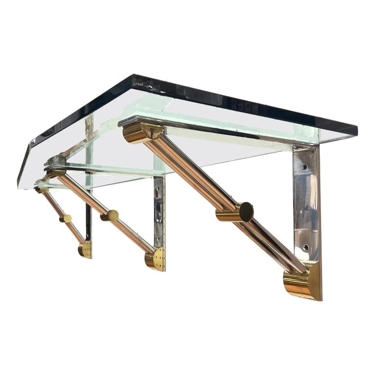 Brass and Stainless Steel Wall Shelf attb to Karl Springer: Introducing the Brass and Stainless Steel Wall Shelf in the style of Karl Springer - the perfect blend of functionality and style. Crafted from high-quality glass and metal, this wall shelf is designe
