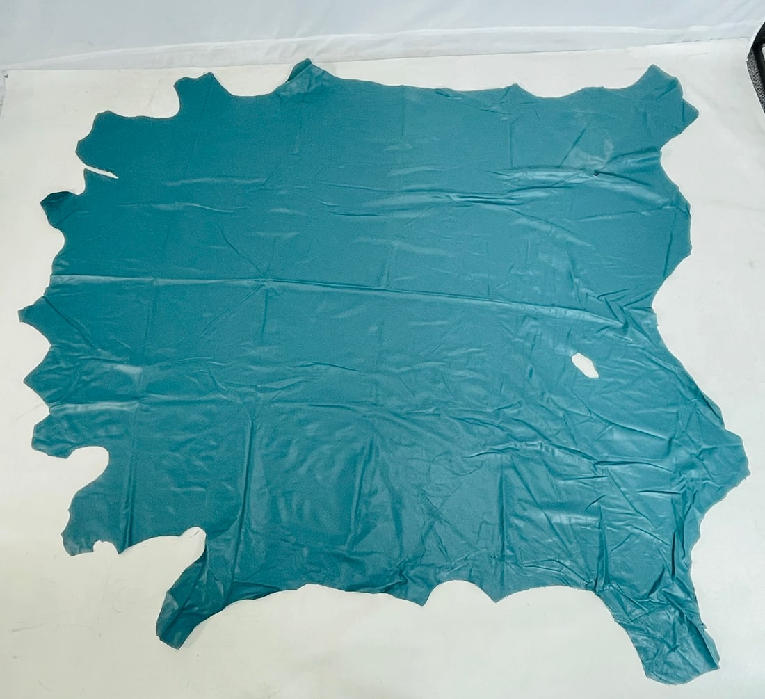Blue Leather Hide: Blue leather hide, unmarked. Measurements: 98 inches long x 95 inches wide. (all measurements are approximate and to the widest and longest points) All items are sold as is. The auction house does n