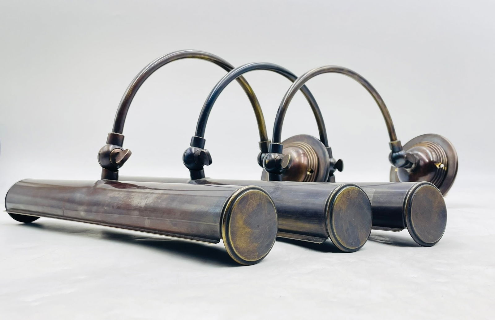 Set of Mid Century Style 3 Wall Sconces in Antique Brass: Beautiful set of 3 solid brass wall lights or sconces in the midcentury modern style. The pieces have an adjustable shade and they are perfect fore reading or art lights. Measurements: 14 inches wid