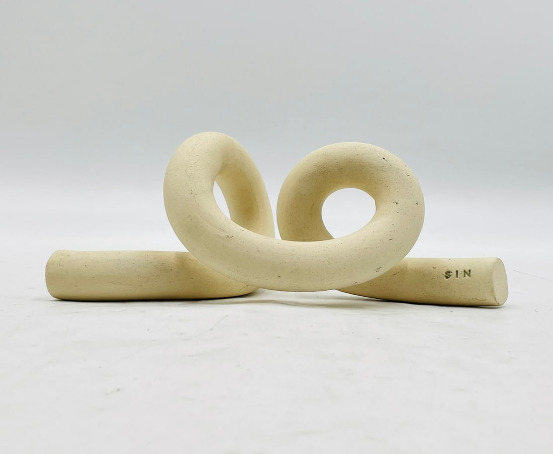 Ceramic Knot Shaped Object of Art: Designed and manufactured in Brooklyn New York, this knot shaped piece of art is made out of stoneware ceramic. Signed "SIN" Measurements: 10 inches wide x 5.25 inches deep x 3 7/8 inches high. All