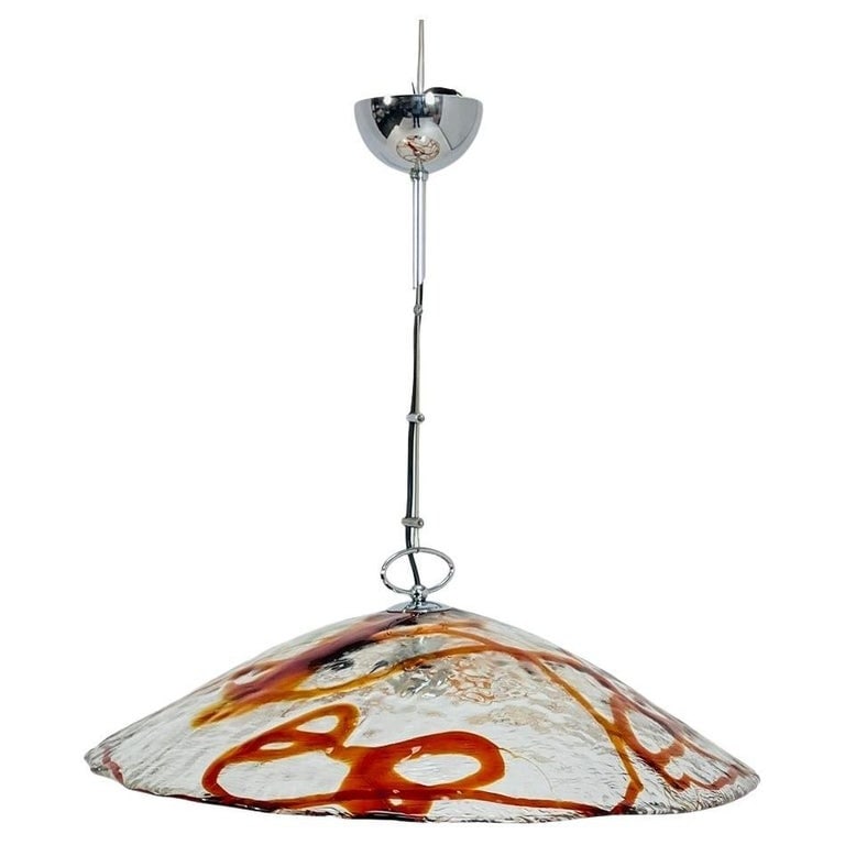 Vintage Murano Glass Chandelier by Mazzega, Italy 1960's: Illuminate your space with the elegance of yesteryear with this Vintage Murano Glass Chandelier by Mazzega, crafted in Italy in the swinging 60s. The stunning combination of orange and clear Murano gl