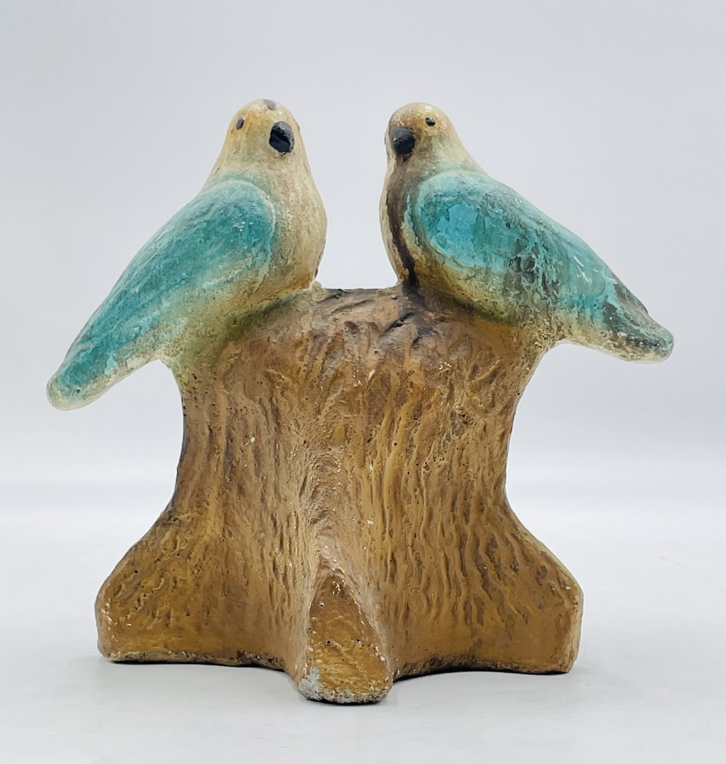 Mid-Century Ceramic Sculpture of Two Birds on Tree Stump: A delightful mid-century ceramic sculpture featuring two stylized birds perched atop a tree stump. The birds are glazed in turquoise tones with beige and brown accents, while the base mimics the textu