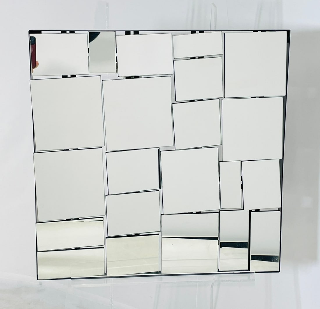 Fragmented Glass Wall Mirror, Postmodern Design: Striking postmodern wall mirror featuring a geometric mosaic of raised mirrored panels arranged at varying depths. Reminiscent of designs by Neal Small, this piece creates a bold three-dimensional eff