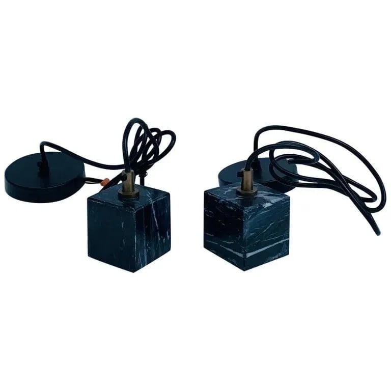 Pair of Brass & Faux Marble Pendant Lights: Beautiful pair of faux black marble pendant lights with brass accents.Manufactured in 2017.Measurements:2 7/8 inches square x 63 inches in length cable and canopy.All items are sold as is. The auction