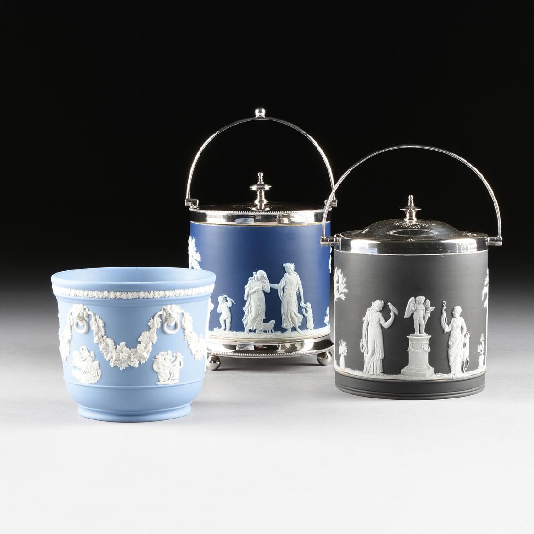 A GROUP OF THREE WEDGWOOD JASPERWARE CONTAINERS, CIRCA: A GROUP OF THREE WEDGWOOD JASPERWARE CONTAINERS, CIRCA 1890-1951, comprising a dark blue jasper dip biscuit jar with cameo decoration based on "An Offering to Peace," Etruria, circa 1890, fitted with