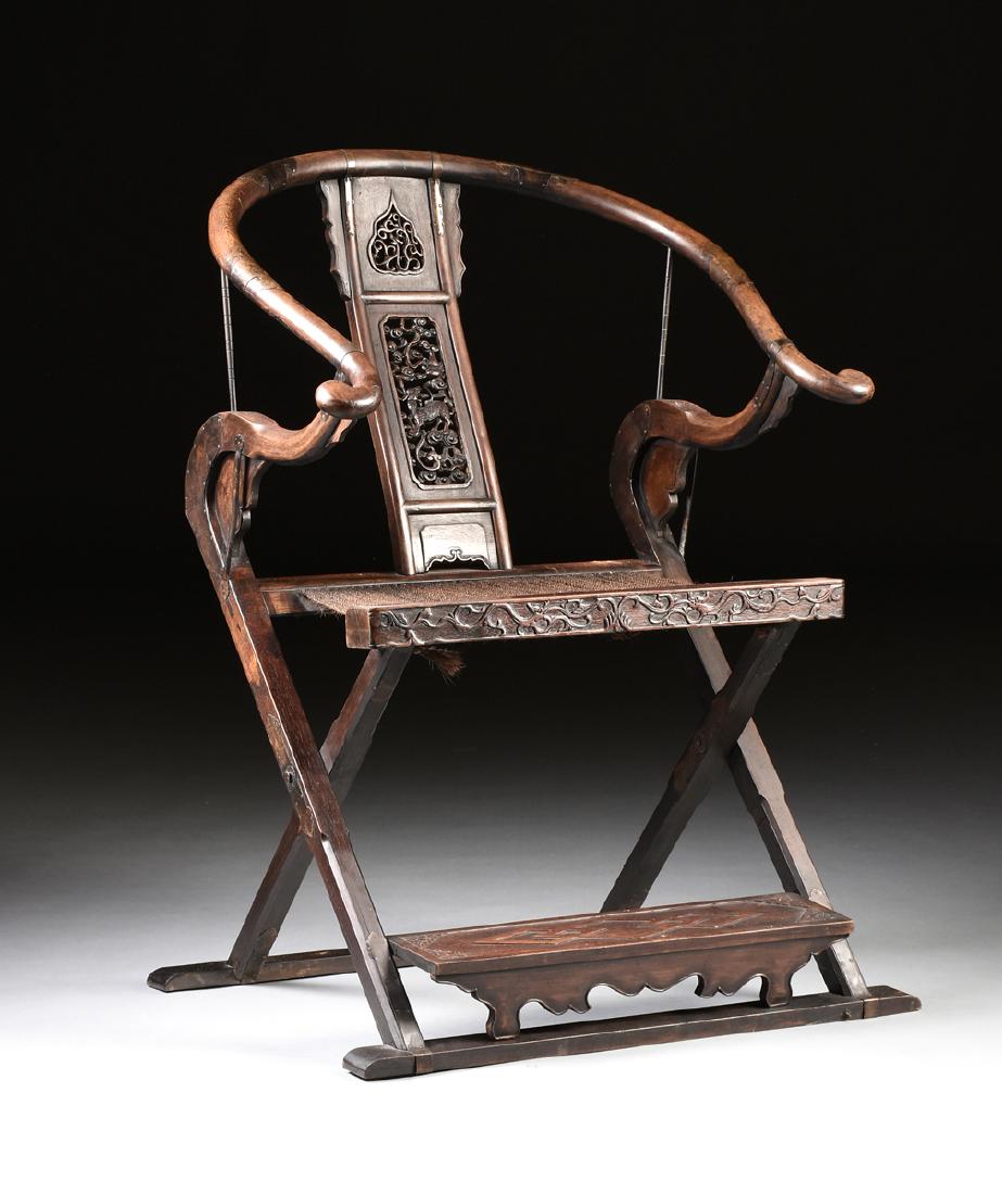 A CHINESE MING DYNASTY STYLE CARVED JICHIMU AND WALNUT: A CHINESE MING DYNASTY STYLE CARVED JICHIMU AND WALNUT FOLDING JIAOYI "HUNT" CHAIR, REPUBLIC PERIOD (1912-1949), the scrolling yoke form crest above a rectangular splat enclosing a pierced ruyi panel 