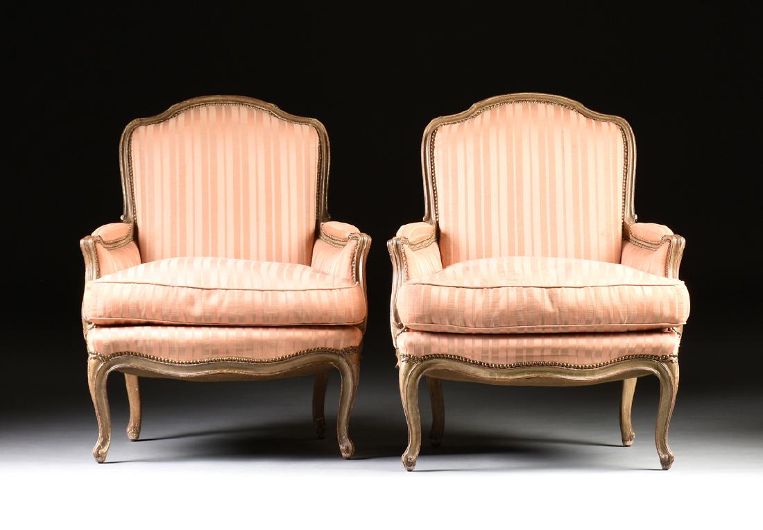 A PAIR OF LOUIS XV STYLE PAINTED BEECH BERGÈRE EN: A PAIR OF LOUIS XV STYLE PAINTED BEECH BERGÈRE EN CABRIOLET, LAST HALF 19TH CENTURY, PROBABLY FRENCH, the arched shield form backs over bombe cushioned seats, within upholstered arms, on cabriole leg