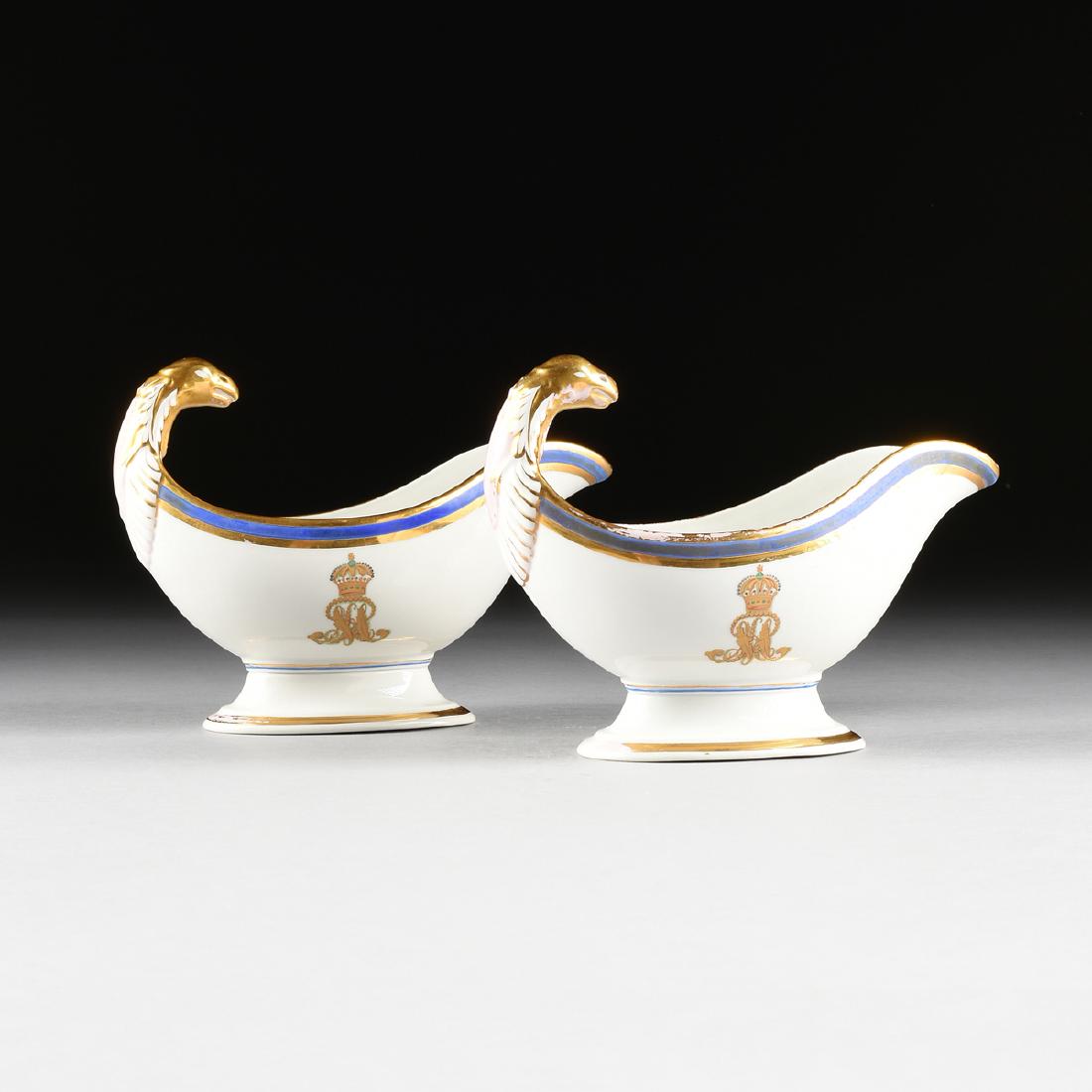 A PAIR OF FISCHER & MIEG PORCELAIN SAUCE BOATS WITH: A PAIR OF FISCHER & MIEG PORCELAIN SAUCE BOATS WITH CYPHER OF KING GEORGE V OF HANOVER, PIRKENHAMMER, AUSTR0-HUNGARY, CIRCA 1857-1915, the white porcelain sauce boats with gilt griffin head handles an